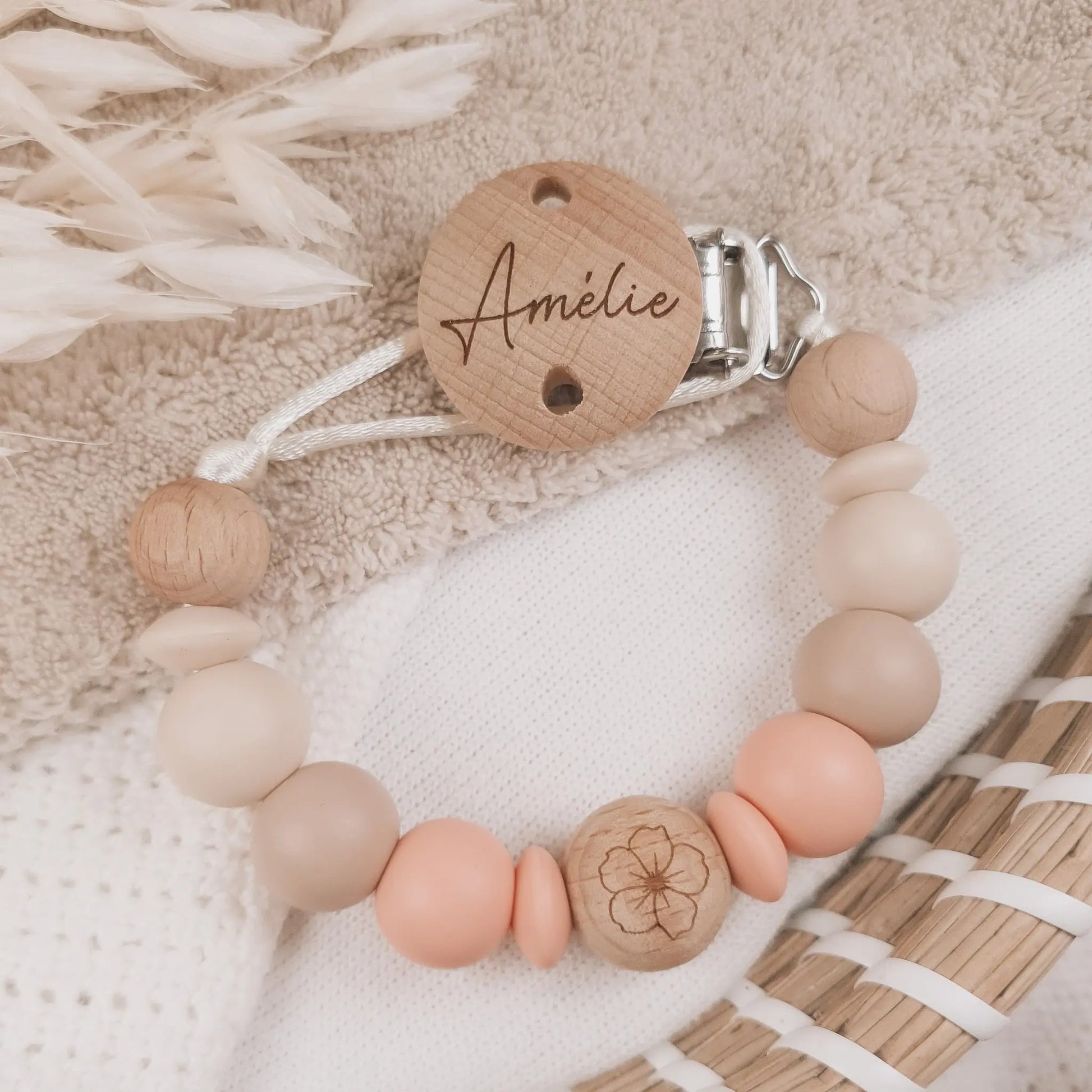 Gepersonaliseerd speenkoord met naam gegraveerd op de clip en siliconen kralen in beige en zalm met houten details.